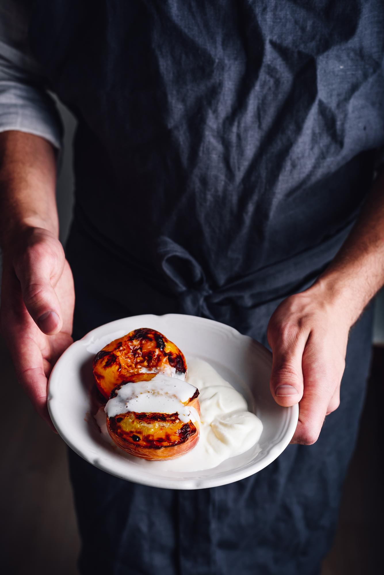 Instructor preparing a plated dish in a calm studio